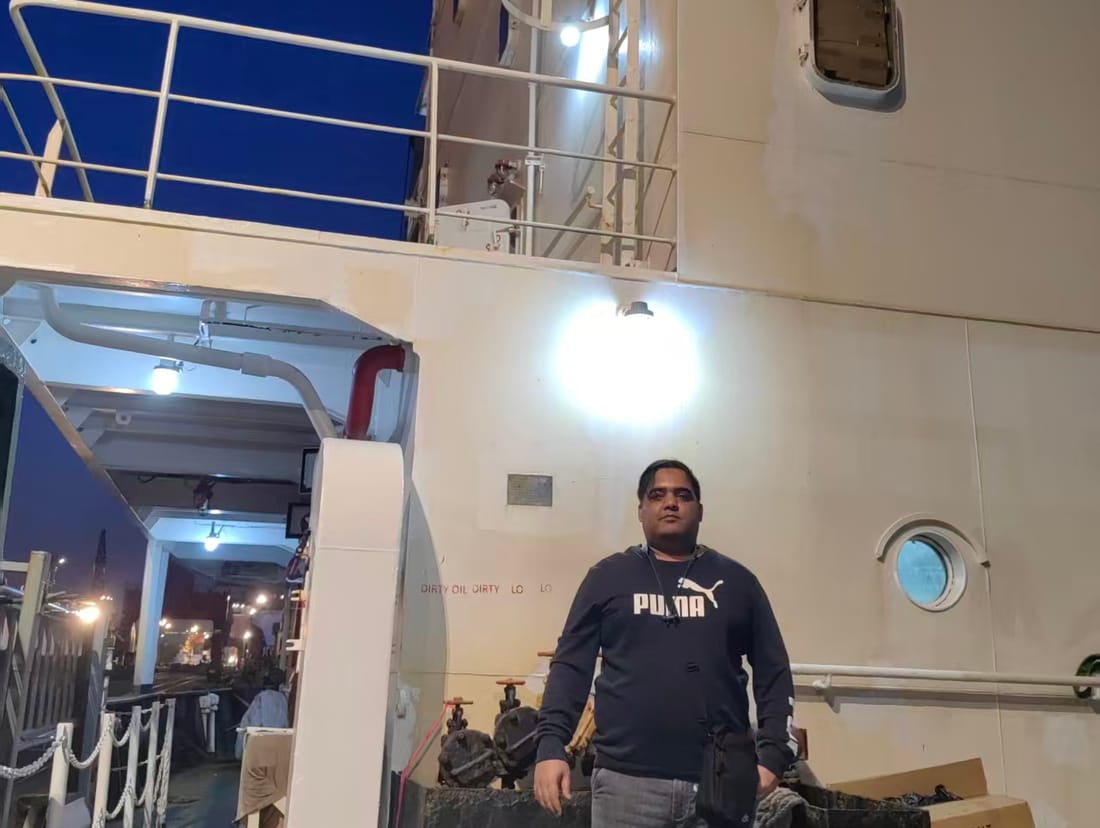 On a cargo ship deck at night, expediting a shipment